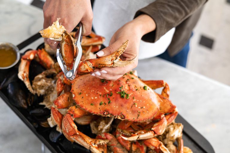 Woman cracking Dungeness crab