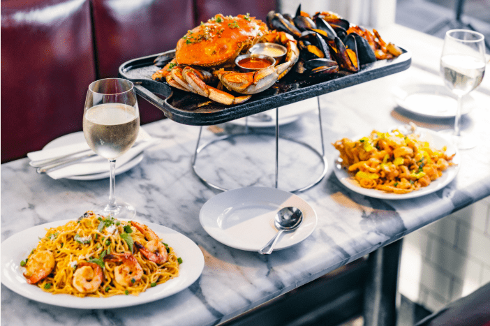 Glass of white wine with seafood dishes at Crab House