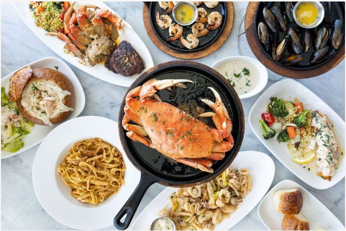 Various seafood dishes on a table at Crab House on Pier 39