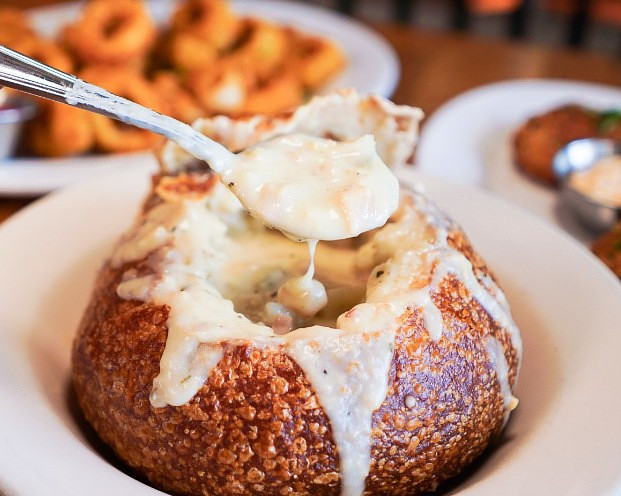 Menu item image showing food to try in San Francisco at Crab House Pier 39, the clam chowder in sourdough bread bowl 